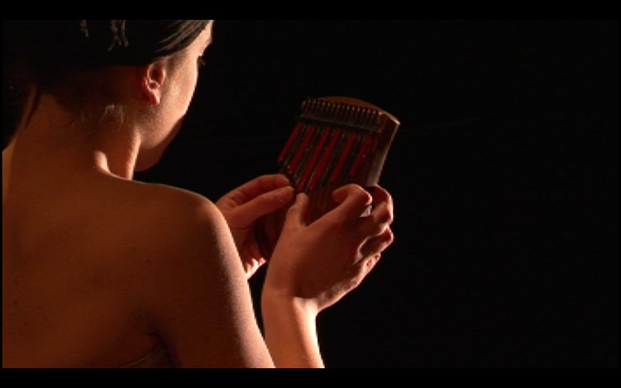 Claudia Hansen playing kalimba in the Music Theater performance Depending by Shawn And The Zebra